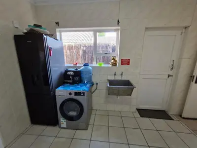a kitchen with a washing machine and a sink at Regent Casa's - Cape Towns Blouberg Area - Where 20 people can stay in Cape Town