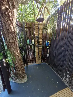 a fence with a tree in front of a tree at Regent Casa's - Cape Towns Blouberg Area - Where 20 people can stay in Cape Town