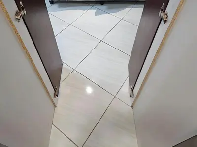a hallway with a white tile floor in a building at Goshen Lodge Spencer in Cape Town