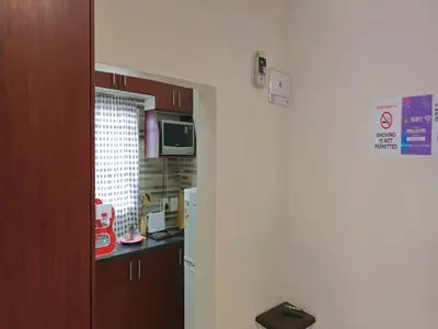 a kitchen with a sink and a microwave at Goshen Lodge Spencer in Cape Town