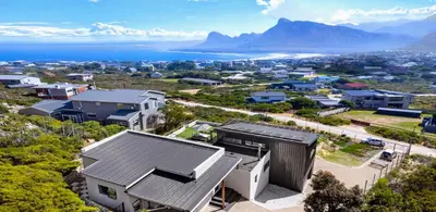 an aerial view of a city with mountains in the background at The Baydreamer, where the view soothes your soul in Pringle Bay
