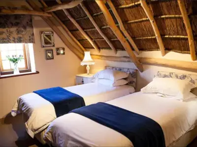 two beds in a room with a attic at Champagne De Kleijne Bos Pty Ltd in Paarl