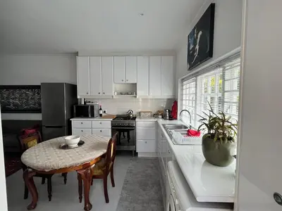 a kitchen with a table and a small table with a table at Somerset West All Stay 2 in Somerset West