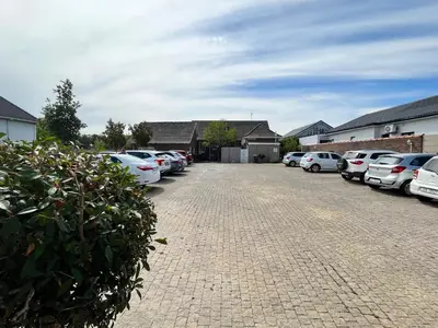 a row of cars parked in a parking lot at Somerset West All Stay 2 in Somerset West