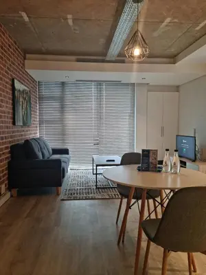 a living room with a couch and a table at Matrix by Smart City Stays in Cape Town