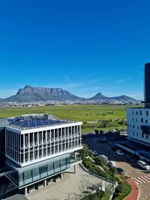 a view of a building with mountains in the background at Matrix by Smart City Stays in Cape Town