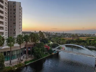 a bridge over a river in a city with buildings at Knightsbridge Superior Apartments in Cape Town