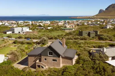 an aerial view of a house in a suburb at Secure, luxurious with lovely views in Pringle Bay