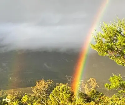 a rainbow in front of a mountain with clouds at 31 on Witzenberg, Tulbagh in Wolseley