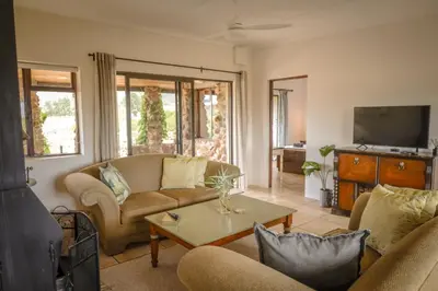 a living room with two couches and a tv at 31 on Witzenberg, Tulbagh in Wolseley