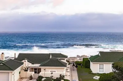 a view of the ocean from a house at Whale Rock 25 in Hermanus