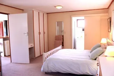 a bedroom with a large white bed in a room at The View Upstairs - A spacious apartment with a view in Durbanville