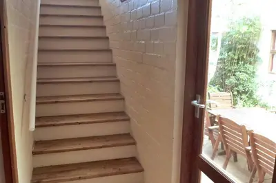 a set of stairs next to a door at The View Upstairs - A spacious apartment with a view in Durbanville