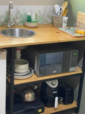 a microwave sitting on a shelf next to a sink at Mia Amore in Caledon