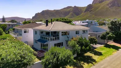 an aerial view of a house with mountains in the background at The Mountainview Family Retreat in Hermanus