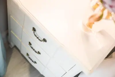 a white dresser with brass pulls in a room at 13 La Gratitude Luxury Apartment-with backup power for loadshedding in Stellenbosch