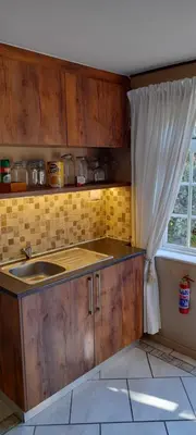 a kitchen with a sink and a window at Lovely Kaapgracht, rental unit with free parking in Cape Town