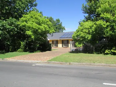 a house with a solar roof on the side of the road at Lovely Kaapgracht, rental unit with free parking in Cape Town