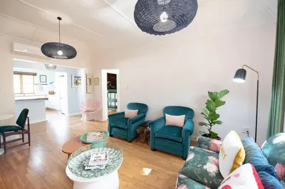 a living room with a couch and chairs and a table at Boho Chic Apartment Stellenbosch in Stellenbosch