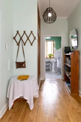 a living room with a table and a kitchen at Boho Chic Apartment Stellenbosch in Stellenbosch