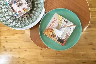 two plates on a table with a magazine at Boho Chic Apartment Stellenbosch in Stellenbosch