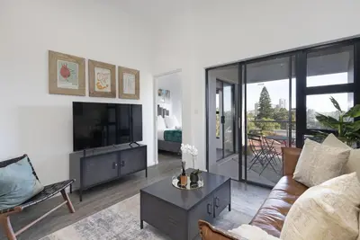 a living room with a couch and a tv at Atlantic Port 9 by Host Agents in Bloubergstrand