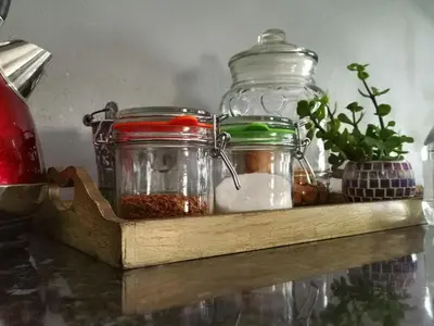 a wooden shelf with jars of spices and herbs at Somerset west Mountain road cottage in Cape Town