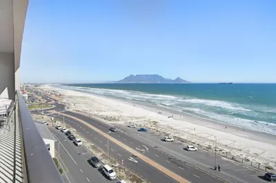 a view of a beach and the ocean from a building at Witsand 804 in Bloubergstrand