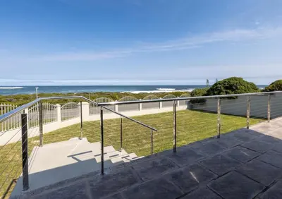 a balcony with a view of the ocean at Seafront Retreat in Sandbaai in Hermanus
