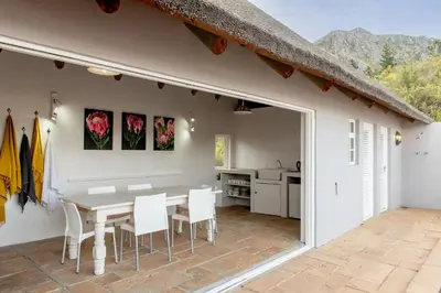 a kitchen and dining room with a table and chairs at Faraway Estate in Villiersdorp