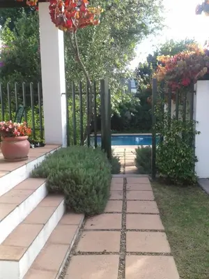 a garden with a fence and some plants at Sunny Lane in Franschhoek