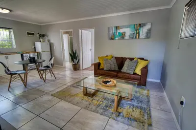 a living room with a couch and a table at Magnificent Apartment in Cape Town