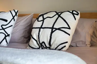 a bed with two pillows on top of it at Magnificent Apartment in Cape Town