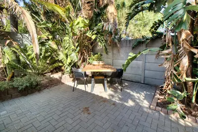 a table and chairs sitting on a patio at Magnificent Apartment in Cape Town