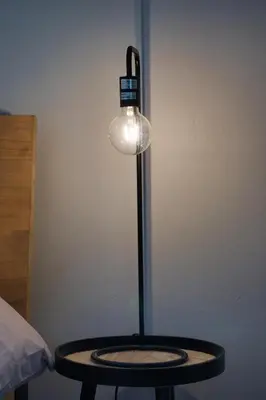 a lamp sitting on a table next to a bed at Magnificent Apartment in Cape Town