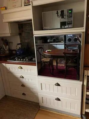 a kitchen with a table and a microwave at 5 BEDROOM CAPE TOWN FAMILY HOME PET FRIENDLY in Cape Town