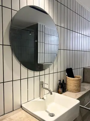 a bathroom with a sink and a mirror at The Paarl Grand in Paarl