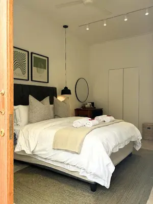 a bedroom with a large bed with two towels on it at The Paarl Grand in Paarl
