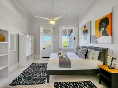 a bedroom with a large bed in a room at Obs Loft Apartments Observatory in Cape Town