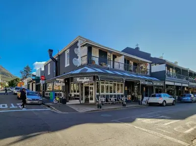 a building on a street with cars parked in front of it at Obs Loft Apartments Observatory in Cape Town