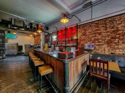 a bar in a restaurant with a brick wall at Obs Loft Apartments Observatory in Cape Town
