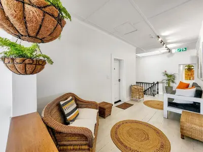 a living room with a couch and chairs at Obs Loft Apartments Observatory in Cape Town