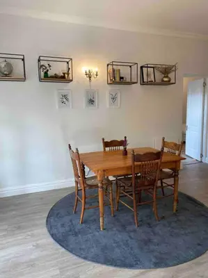 a dining room with a wooden table and chairs at Auret Street Garden Cottage in Paarl