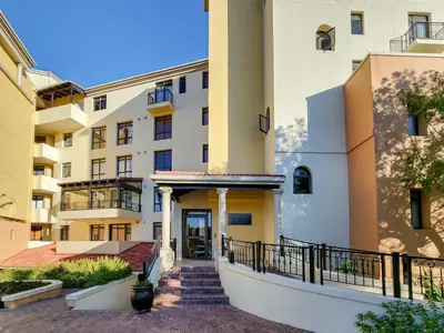 an apartment building with a staircase leading to the entrance at Family-Friendly Home with Ample Space in Cape Town