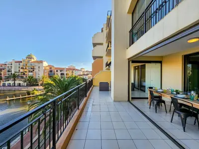 a balcony with tables and chairs on a building at Family-Friendly Home with Ample Space in Cape Town