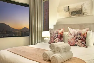 a bedroom with a bed with towels on it at Manhattan 1003 in Cape Town