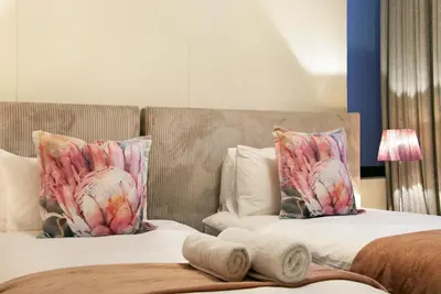 a bedroom with two beds with pillows at Manhattan 1003 in Cape Town