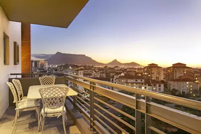 a balcony with a table and chairs with a view at Manhattan 1003 in Cape Town