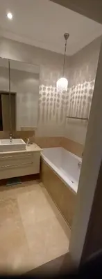 a bathroom with a tub and a sink and a mirror at 305B Bayview Breathe in Hermanus