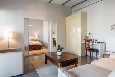 a living room with a couch and a table at Sunset-Loft in Cape Town